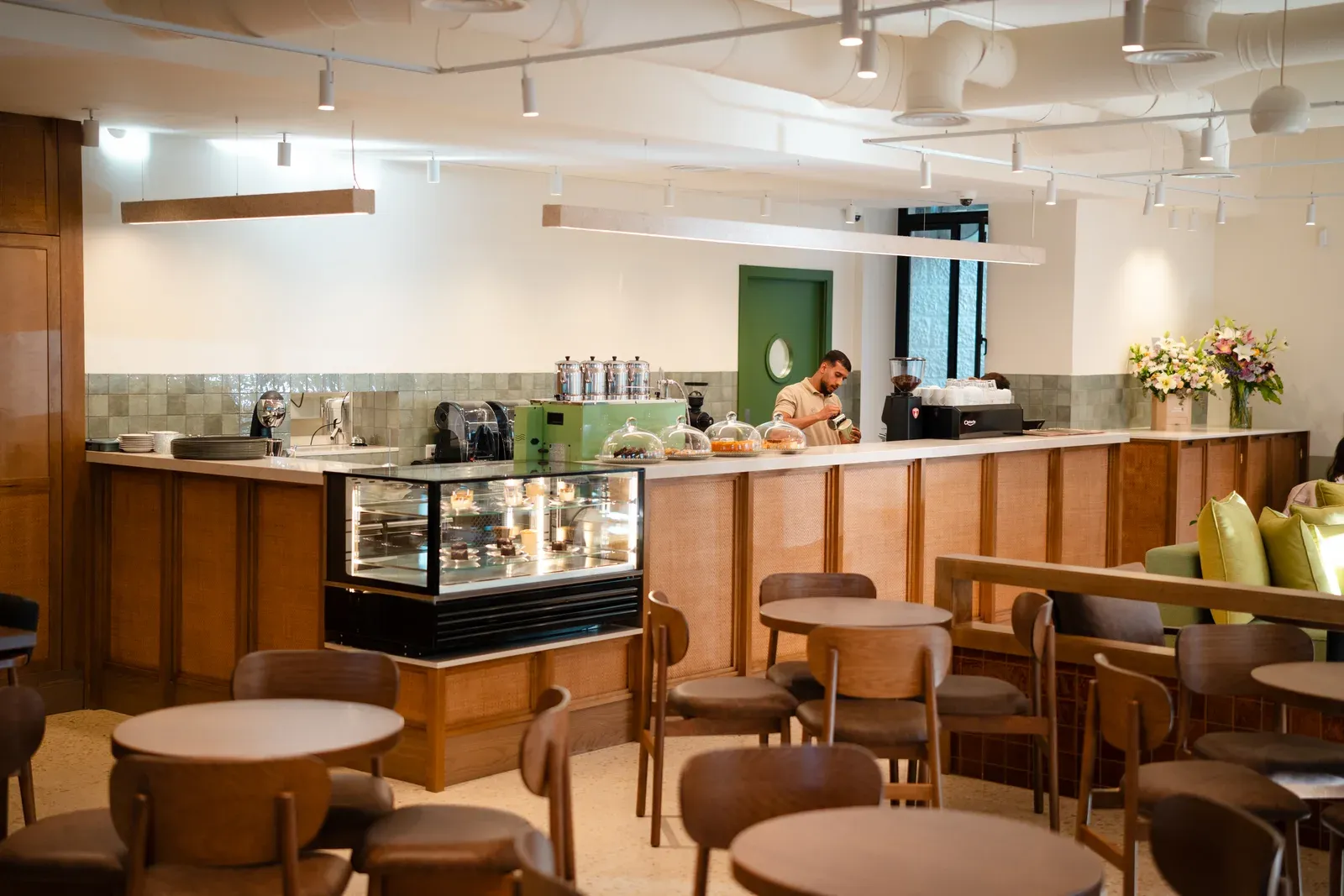 Asasi Café service counter and display with seating in the foreground